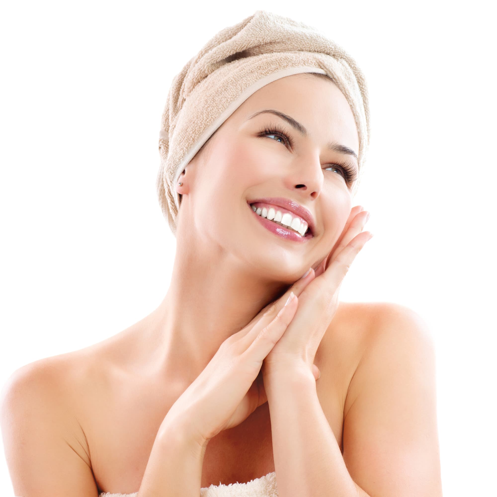Close up of smiling female, hair wrapped in a towel against clean white background representing clean and natural bath and body care.