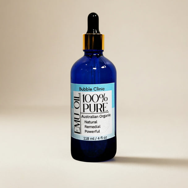 blue glass dropper bottle 100% natural organic Australian Emu Oil organic botanicals in background representing pure organic Australian skincare.