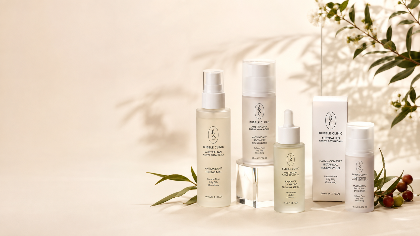 Bubble Clinic Australian Native Botanicals skincare collection with frosted bottles and jars on a soft sage studio background