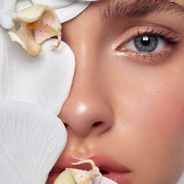 close up of woman's face one eye is covered in natural botanicals representing clean beauty and natural australian skincare.