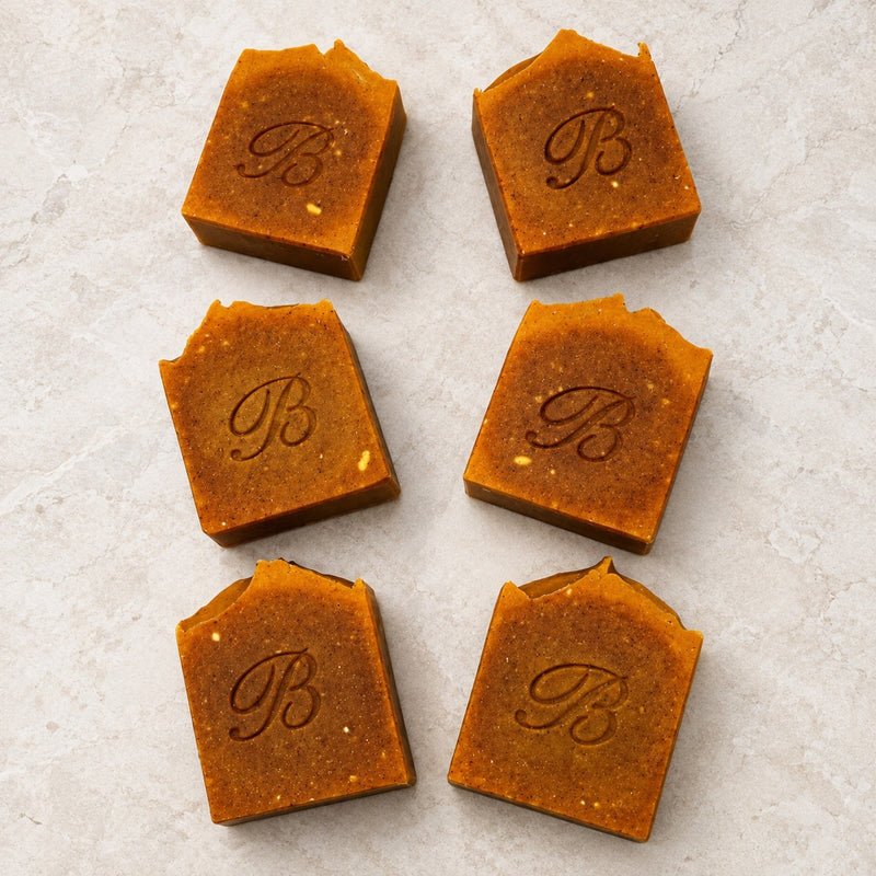 Flat lay of handmade kojic acid turmeric and organic carrot tallow soap bars