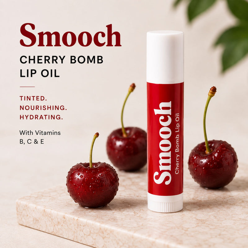 Smooch Cherry Bomb tinted lip oil with sheer cherry tint and vitamins B, C and E - benefits text-tinted, nourishing, hydrating - styled with fresh cherries and