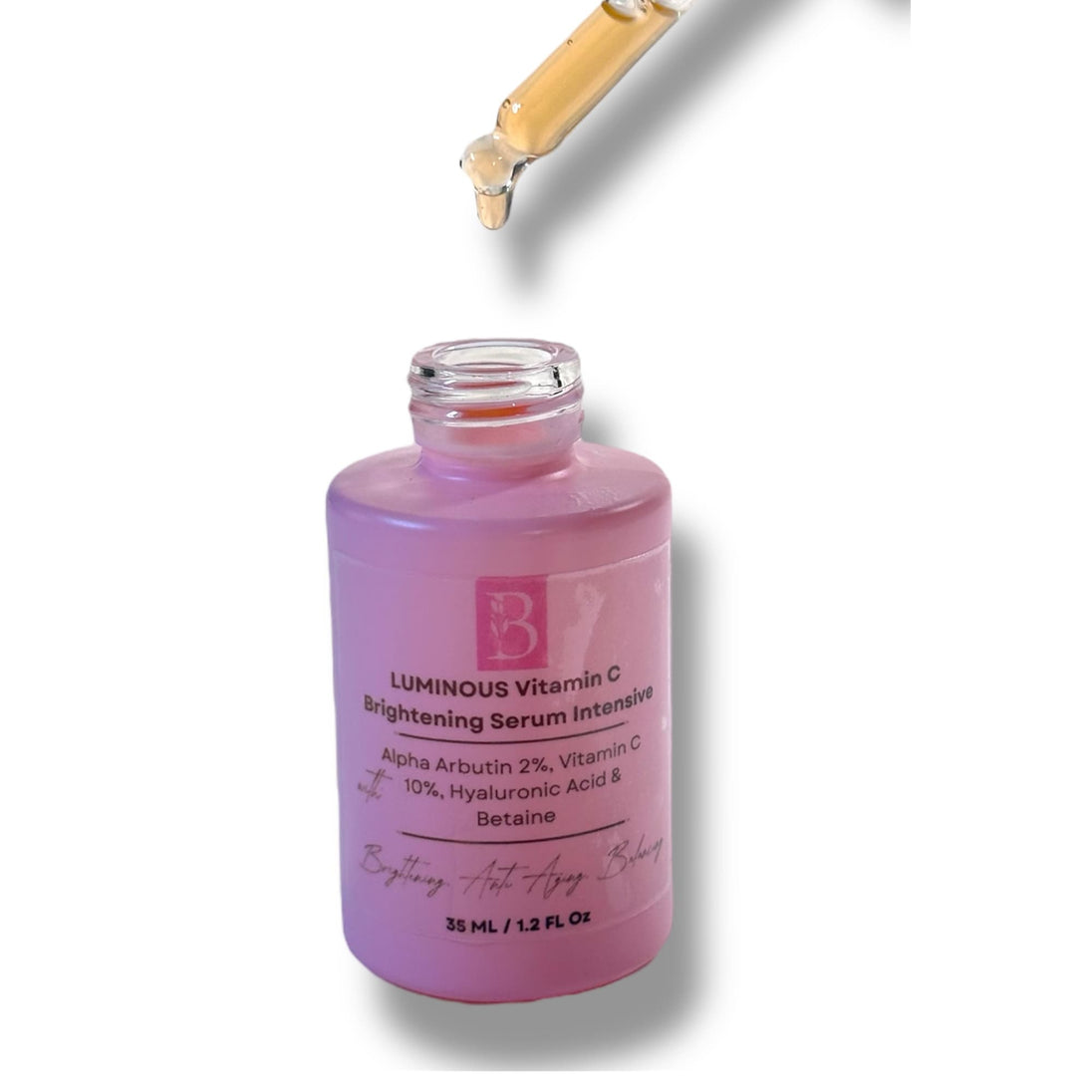 Close-up of pink dropper bottle with orange brightening serum and soft shadow, highlighting clean formula.