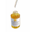Open Centella Ampoule bottle with dropper releasing clear, lightweight serum into the bottle.