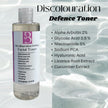 Split image of clear Discolouration Defence Toner bottle beside a list of actives including niacinamide, glycolic acid, alpha arbutin, and hydrating plant extracts.
