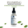 Plumping Hyaluronic Acid Serum in clear glass bottle with white background and green leaves, highlighting all-natural formula with vitamins and extracts.