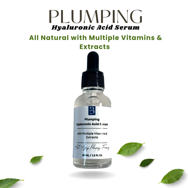 Plumping Hyaluronic Acid Serum in clear glass bottle with white background and green leaves, highlighting all-natural formula with vitamins and extracts.