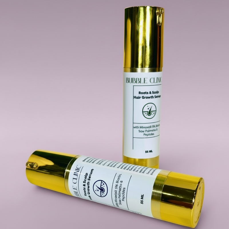 Two gold bottles of minoxidil 5% hair and scalp serum with biotin and saw palmetto on a light grey background