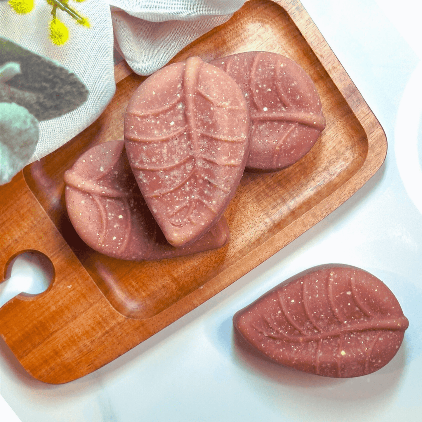 Leaf shaped acne sulphur soap with MSM set against a white background with organic linen and Australian Botanicals representing clean, natural, organic solutions for acne.