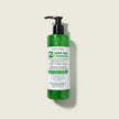 transluscent bottle of BHA salicylic acid Gel Cleanser with tea tree revealing crystal clear green hue of the gel cleanser a beige background representing best Australian acne treatments.