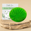 Green anti blemishes soap for sensitive skin on a wooden stand with a 'Bubble Clinic' product card in the background.