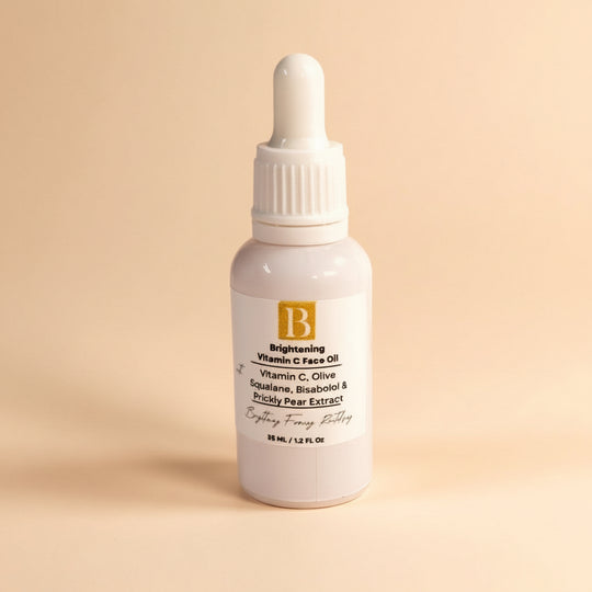 Vitamin C face oil in white serum bottle with dropper, clearly labeled with key active ingredients like rosehip, squalane, and prickly pear.