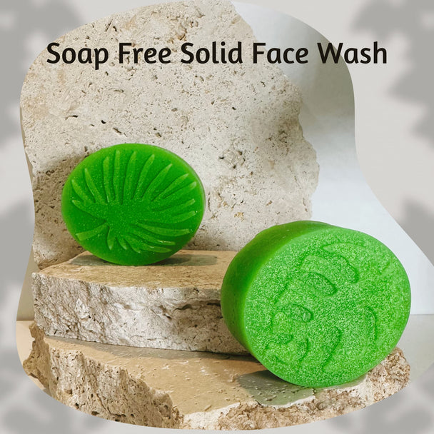two bright green soap free cleansers for acne on natural stone with botanicals representing natural acne care for sensitive skin.