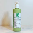 close up of acne control zinc pyrithione cleanser in clear bottle revealing creamy light green hue from comfrey and spirulina infusions on clear backdrop representing best acne treatment Australian made.