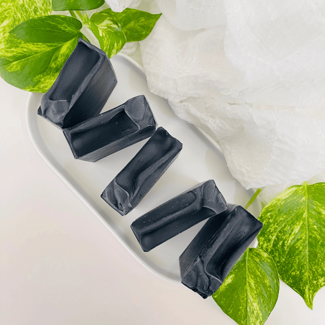 Natural activated charcoal soap for oily acne prone skin. Close up of five bars against clean, bright background representing natural Australian skincare for oily, acne prone skin.