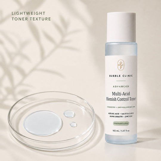 Bubble Clinic Advanced Multi-Acid Blemish Control Toner bottle shown next to a clear petri dish with liquid droplets on a warm beige background with soft leaf shadows.