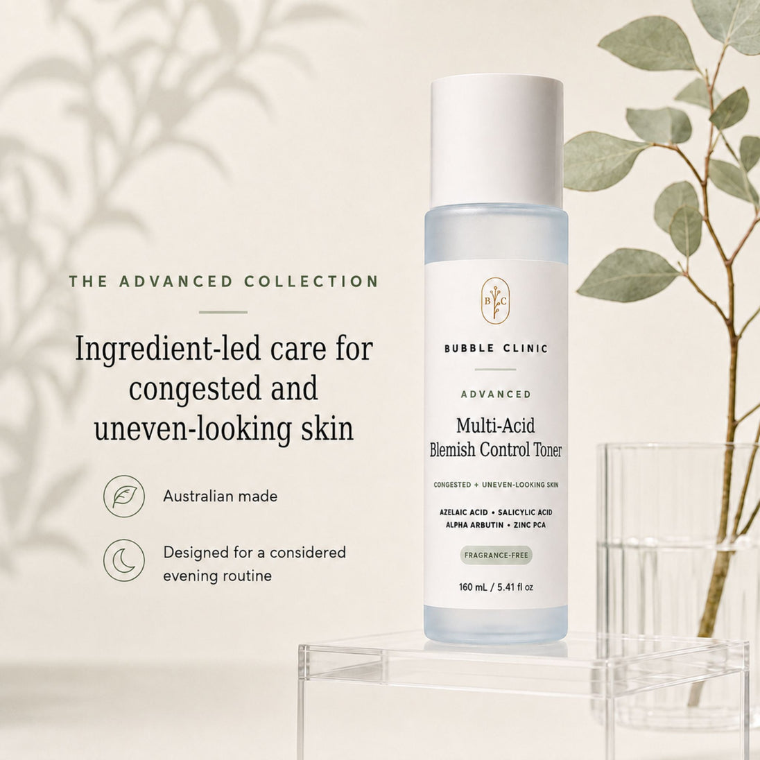 Bubble Clinic Advanced Multi-Acid Blemish Control Toner bottle displayed on a clear acrylic stand, with decorative eucalyptus leaves and a glass on the right, and marketing text on the left against a soft beige background.