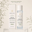 Bubble Clinic Multi-Acid Blemish Control Toner shown with its white retail box and frosted bottle on a clear acrylic stand against a warm beige background with soft leaf shadows.