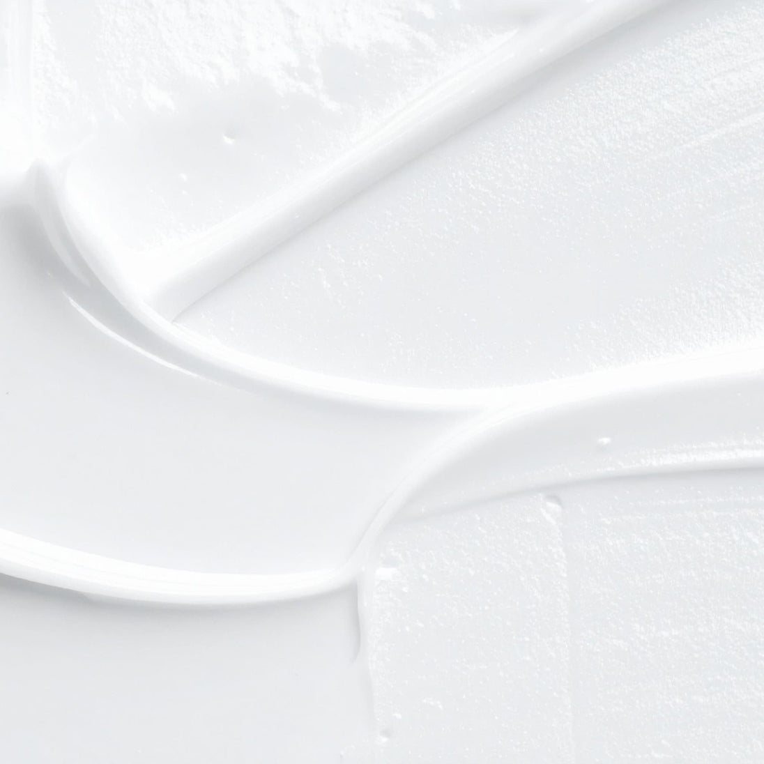 Close-up of light silky swab of brightening vitamin c barrier lotion dark spot skin correcting cream.