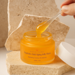 Anti Aging Matrixyl 3000 Orange jar of peptides anti-aging jelly mask with a hand holding a dropper filled with the product.