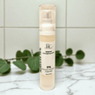 Azelaic Acid 15 percent Skincare product bottle with brand logo on a marble surface with green leaves in the background