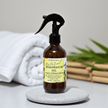 Bottle of natural magnesium oil with a label on a gray surface within a spa background to represent aromatherapy magnesium oil benefits