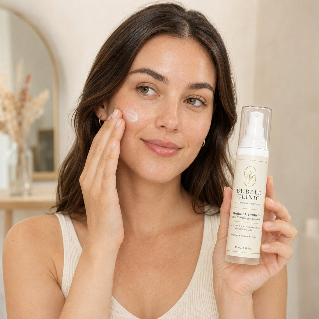 Woman applying Bubble Clinic Barrier Bright Tone Correcting Moisturiser to her cheek