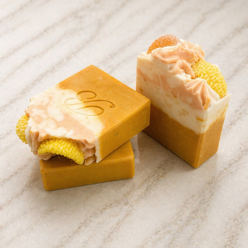 Two Australian-made Kojic Acid Niacinamide Turmeric Soap bars showing their handmade botanical texture