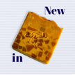 close up of turmeric kojic acid soap with mosaic design. Bright orange hue from turmeric and fresh carrots.