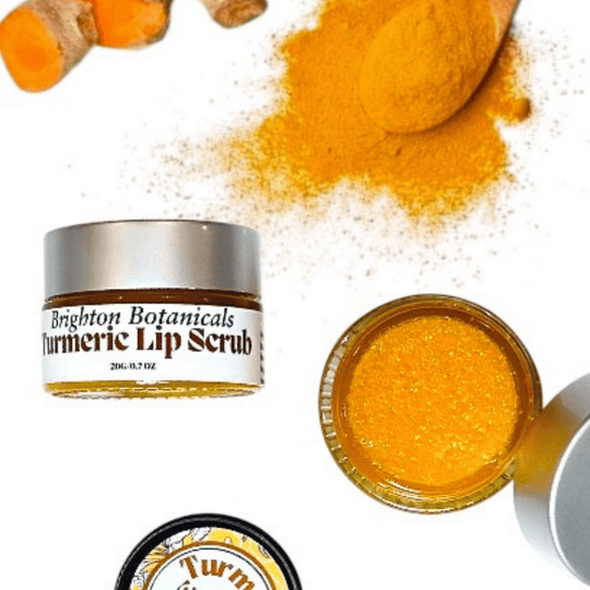 Luxury glass jars of turmeric scrub-one open showcasing natural orange turmeric hue and soft texture with organic turmeric and turmeric powder in the background.
