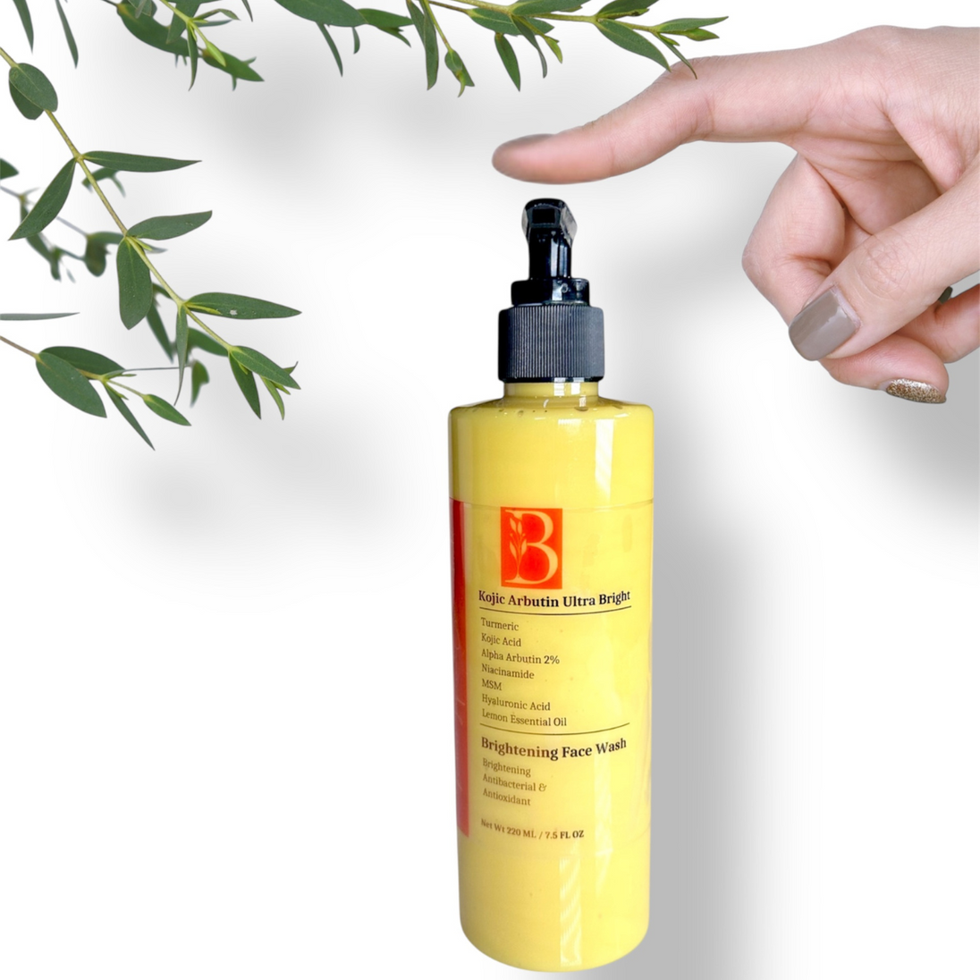 white background with botanicals and image showing clear pump bottle of turmeric kojic acid face wash with finger about to press the pump and white background with botanicals representing gentle natural brightening skincare for sensitive skin