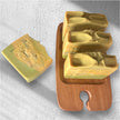 Four bars of Turmeric, Kojic Acid & Alpha Arbutin Brightening Soap on a rustic wooden tray, highlighting its natural formula for glowing skin.