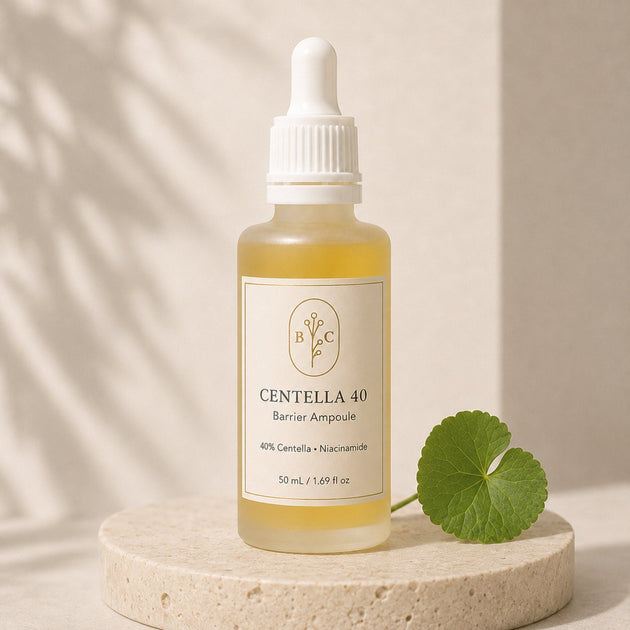 Close-up of golden Centella 40% Barrier Ampoule with a Centella leaf