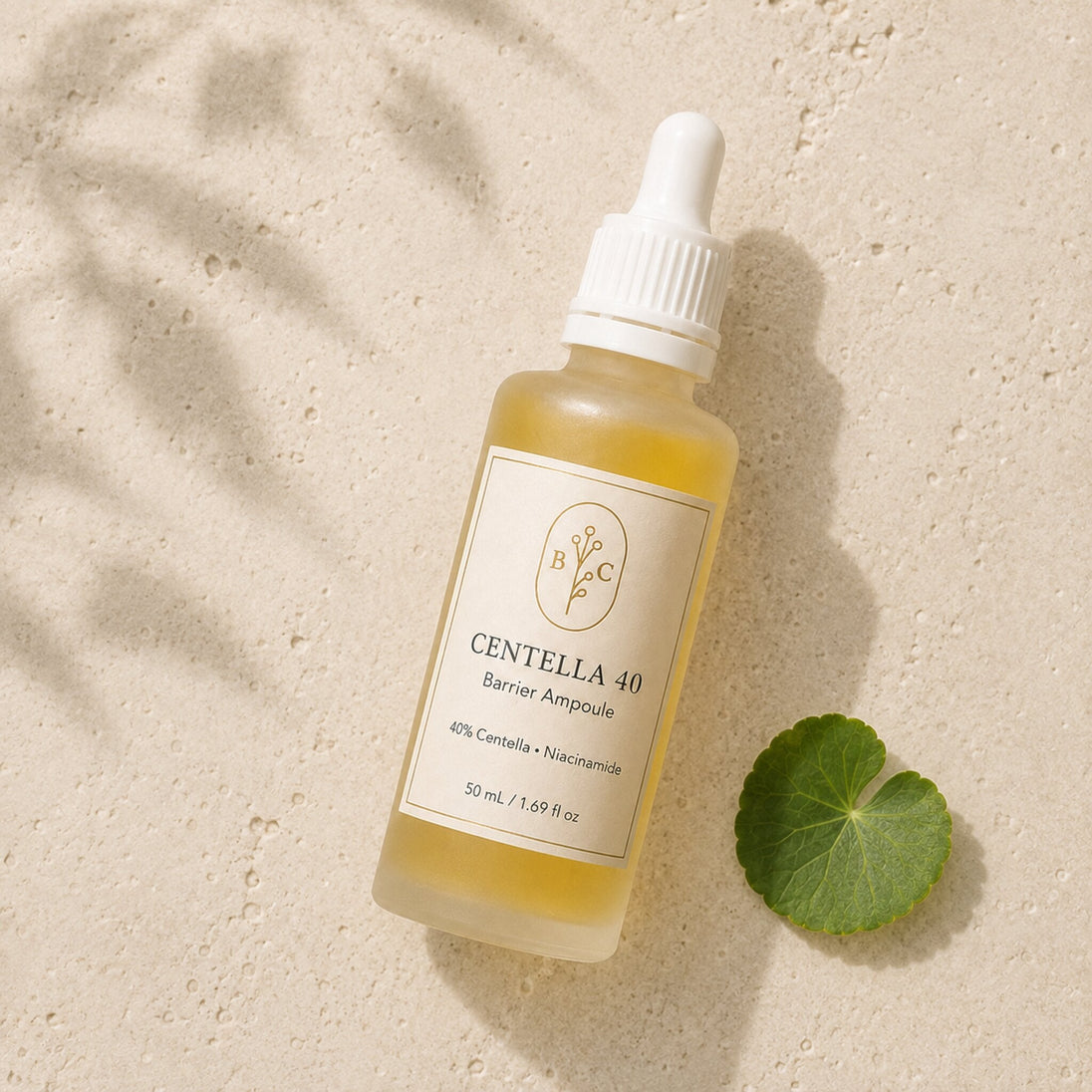 Flat lay of Bubble Clinic Centella 40% Barrier Ampoule with a Centella leaf