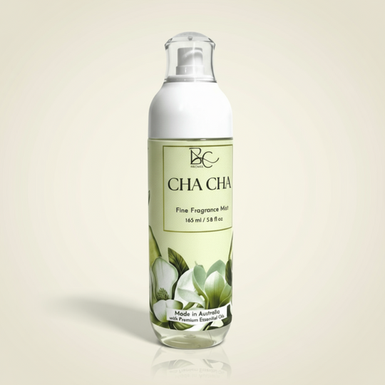 Bottle of Cha Cha fine fragrance mist with a green label on a white background