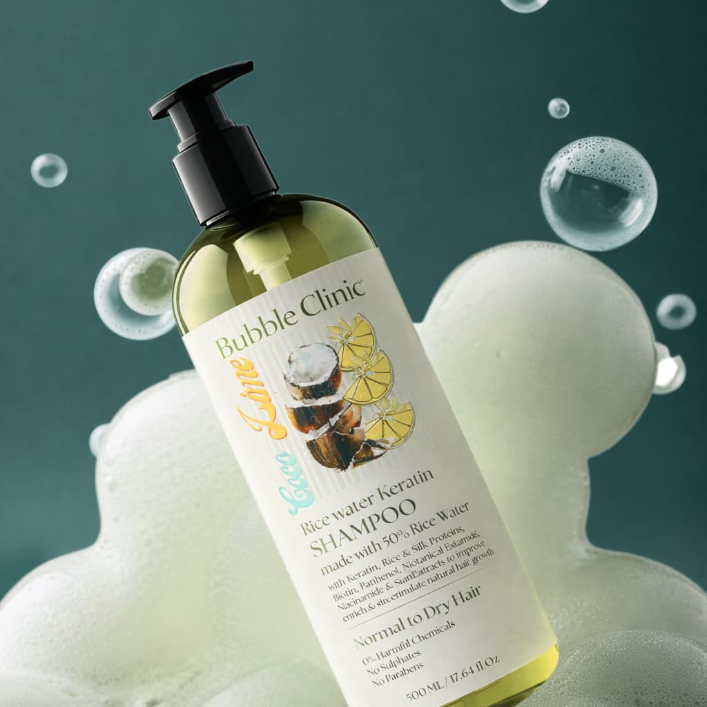 Bottle of Bubble Clinic rice water and keratin  shampoo for dry, damaged and chemically treated hair with bubbles and a green background representing best Australian Sulfate free haircare