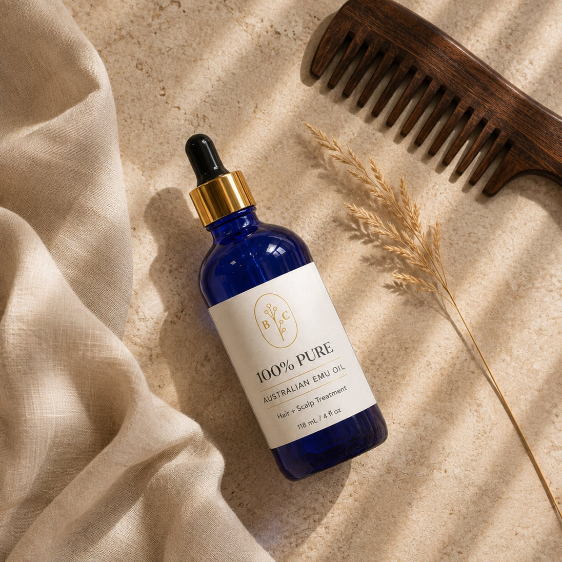 Australian Emu Oil Hair and Scalp Treatment flat lay with wooden comb