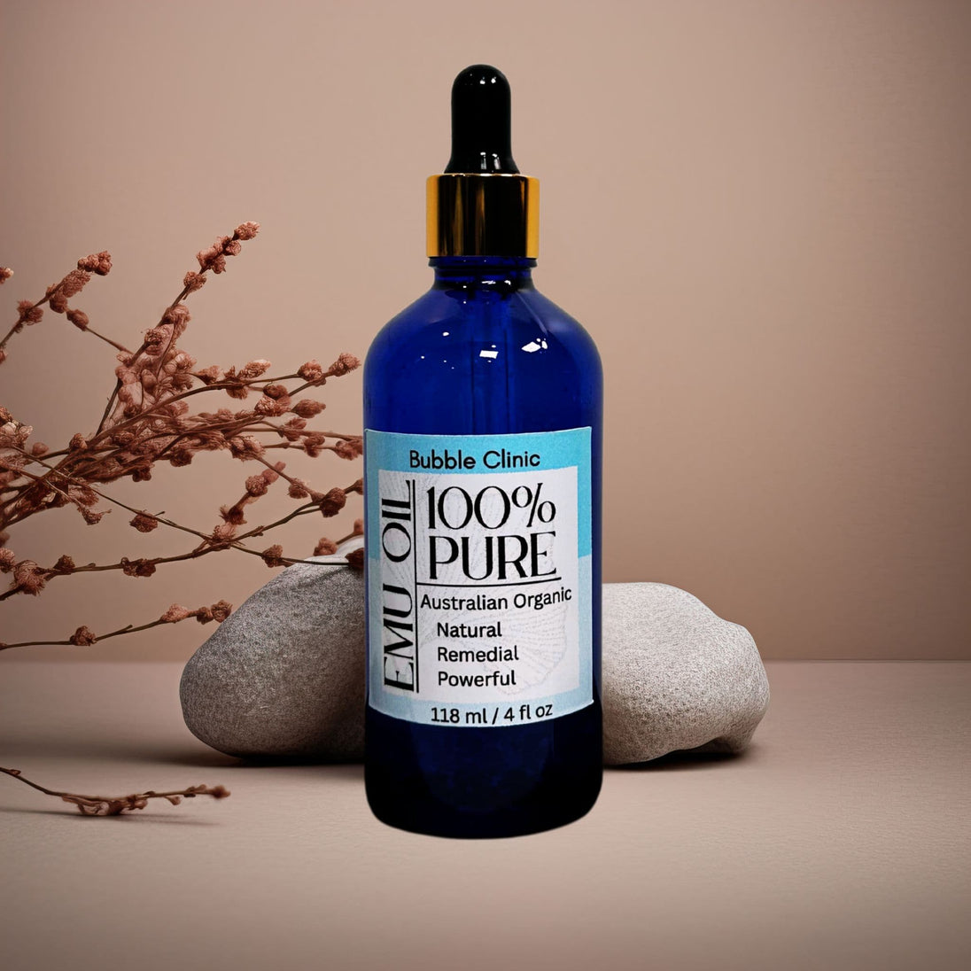 blue glass dropper bottle 100% natural organic Australian Emu Oil organic botanicals in background representing pure organic Australian skincare.