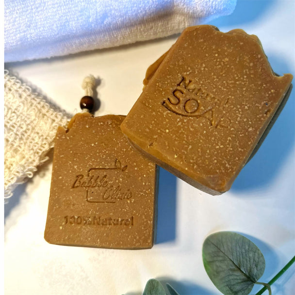 top view close up of 2 natural sulphur soap with emu oil. natural caramel colour gainst white background with botanicals representing natural, Australian Made acne care.