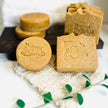 bright close up of two sizes of emu oil sulphur soap with msm with botanicals and natural sisal soap saver in foreground representing all natural Australian Acne and Rosacea skincare.