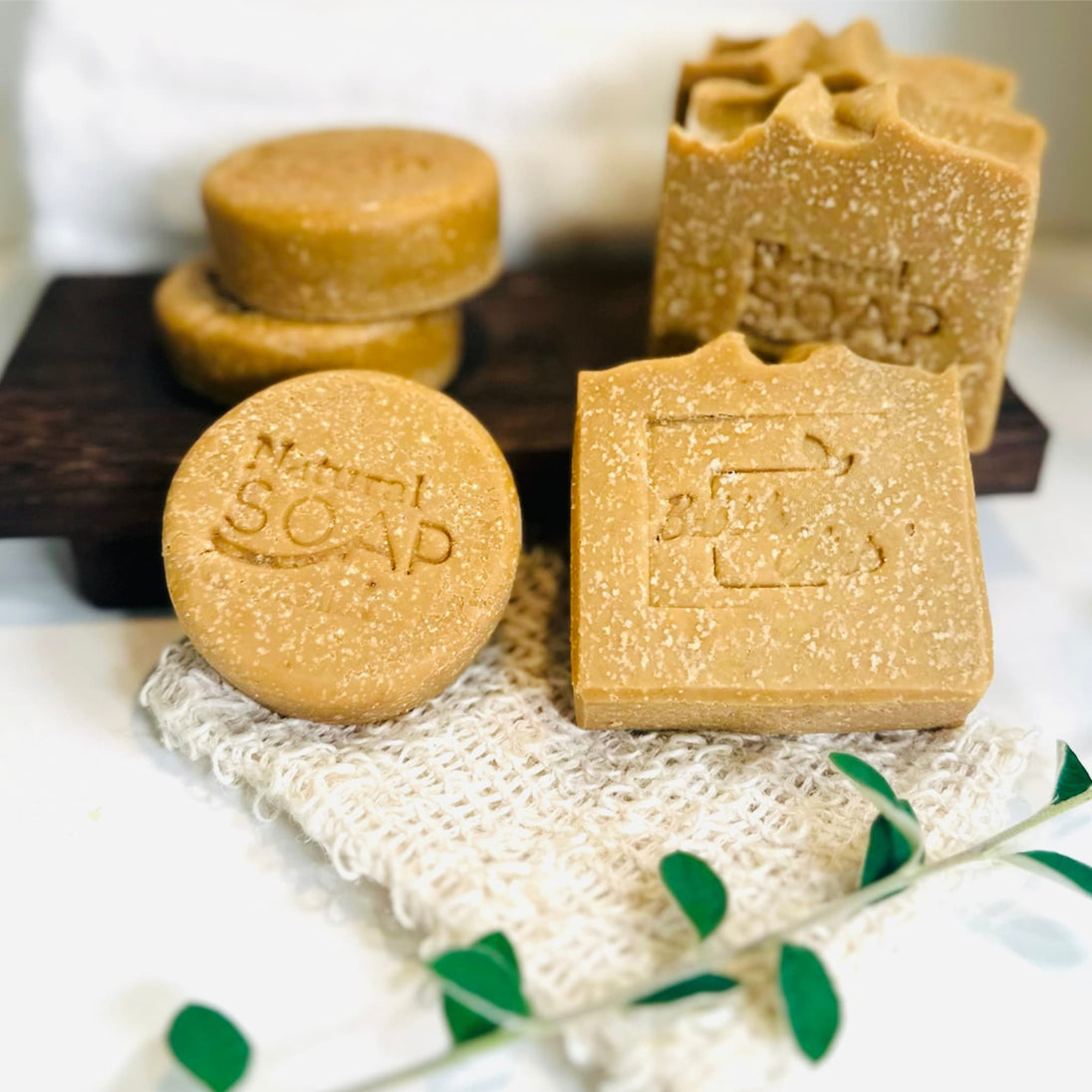 bright close up of two sizes of emu oil sulphur soap with msm with botanicals and natural sisal soap saver in foreground representing all natural Australian Acne and Rosacea skincare.