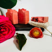 Natural Organic Himalayan Rhubarb Soa[ Bars on organic tray with Roses and Botanicals in the foreground representing natural artisan soap for sensitive skin