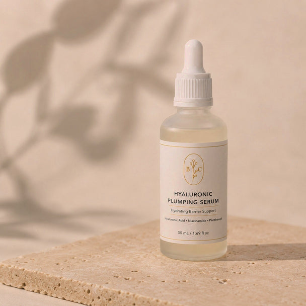 Bubble Clinic Hyaluronic Plumping Serum product on a beige stone background in a 50 mL frosted glass bottle.