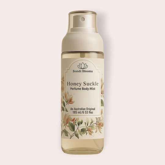 Fine spray mist bottle of Japanese Honey Suckle perfume body mist bottle on a light beige background representing luxury long lasting perfume fragrance mists for body and hair. 