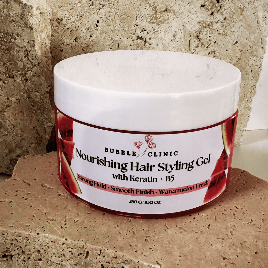 Jar of Bubble Clinic Nourishing watermelon Hair Styling Gel with Keratin and B5 on a textured surface.