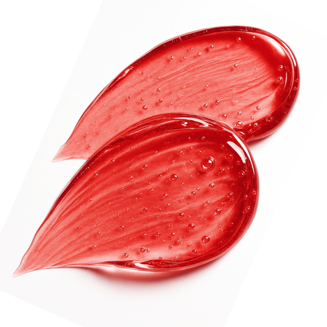 Two smears of red watermelon keratin hair gel highlighting clear glossy texture.