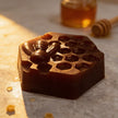 close up of natural brightening kojic turmeric soap bar for uneven skin tone and glowing skin on marble surface with honey jar.