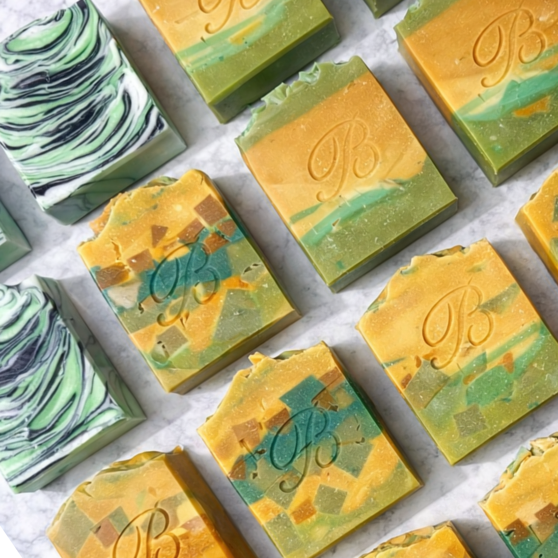 Assorted Turmeric Kojic Acid brightening soap bars with a brand logo on a white background representing best natural brightening skincare Australian Made