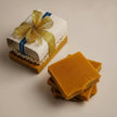 brightening kojic and turmeric soap ends bundle gift packaged with gold ribbon against dark concrete background representing best natural brightening skincare Australian made.