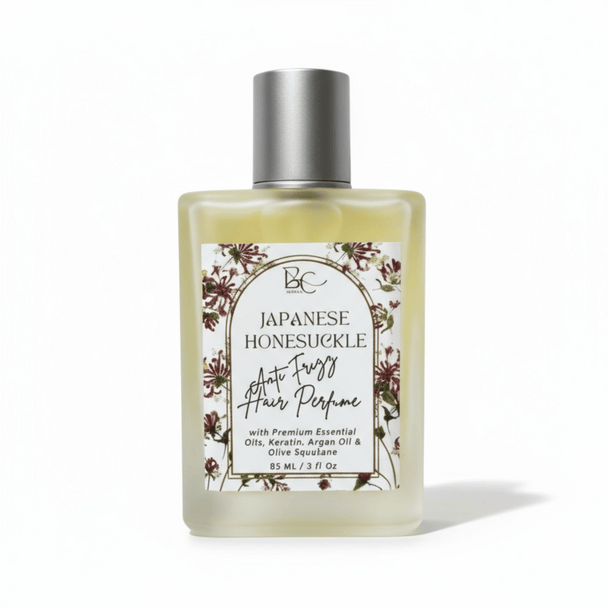 Bottle of luxury hair perfume with keratin, argan oil and Japanese Honeysuckle essential oil with floral label on a white background